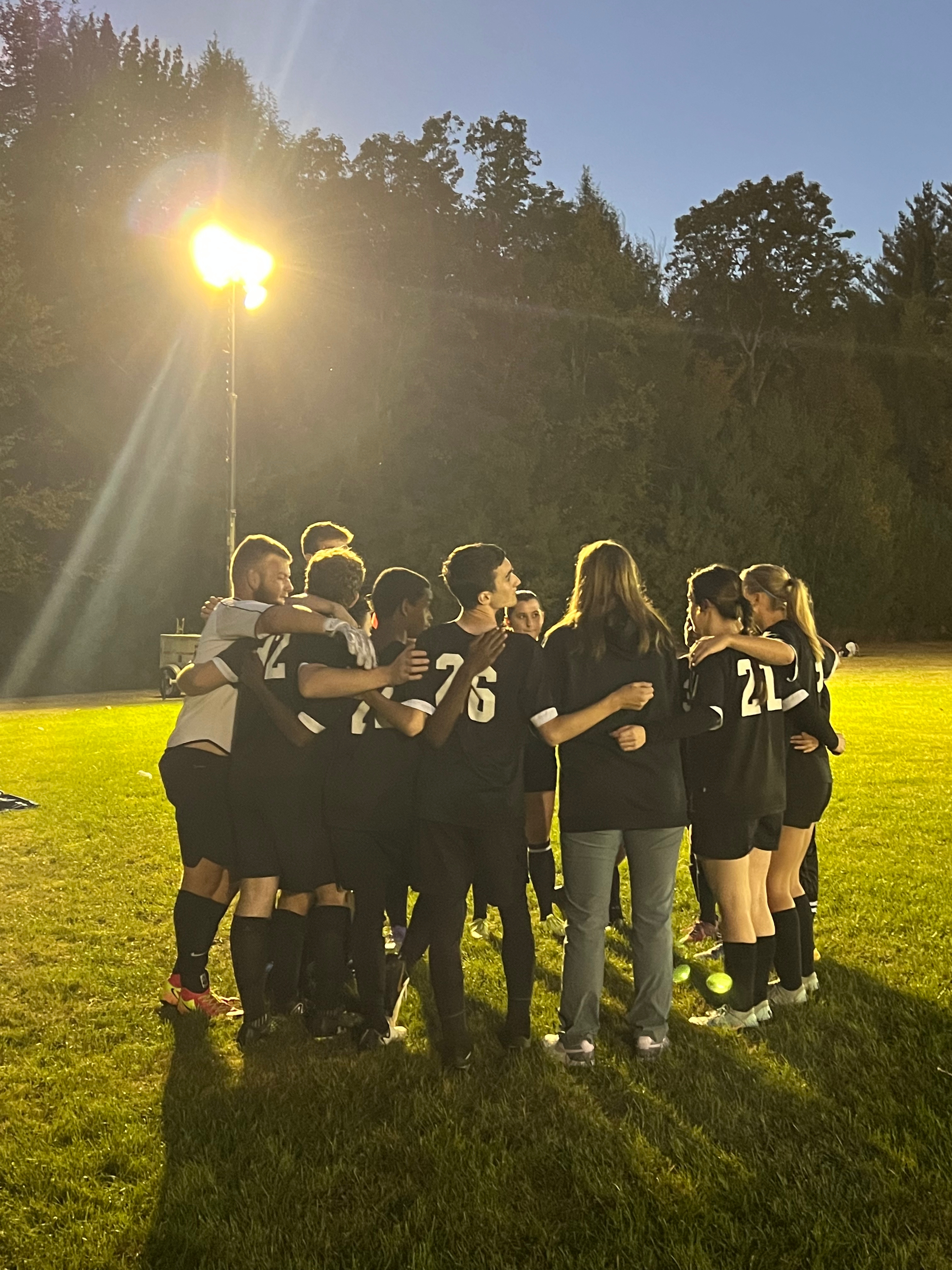 The Jr-Sr High soccer team in a post-game huddle